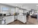 A well lit kitchen with stainless steel appliances, white cabinets, and an open layout to the living room at 681 Home Se Ave, Atlanta, GA 30312
