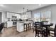 Bright kitchen featuring white cabinetry, granite countertops, modern appliances, and an adjacent dining area at 681 Home Se Ave, Atlanta, GA 30312