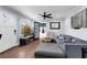 Comfortable living room with a large window, wood floors, a gray couch, and a modern ceiling fan at 681 Home Se Ave, Atlanta, GA 30312