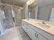 Modern bathroom featuring double sinks, quartz countertop and a glass enclosed shower with tile surround at 1327 Fern Ridge Ct # 27, Norcross, GA 30093