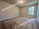 Bedroom with neutral carpeting, neutral paint, and natural light from a large window at 1327 Fern Ridge Ct # 27, Norcross, GA 30093