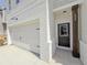 Charming townhouse featuring a garage, front door, and clearly displayed house numbers at 1327 Fern Ridge Ct # 27, Norcross, GA 30093