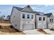 Side view of a townhouse showing painted brick and a two-car garage at 1327 Fern Ridge Ct # 27, Norcross, GA 30093