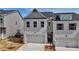 Charming townhouse showcasing painted brick, a garage, and a gabled roof at 1327 Fern Ridge Ct # 27, Norcross, GA 30093