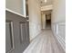 Inviting hallway with gray vinyl floors, modern trim, and gray front door welcomes you inside at 1327 Fern Ridge Ct # 27, Norcross, GA 30093