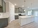 Modern kitchen features gray cabinets, white countertops, and a large island with pendant lighting at 1327 Fern Ridge Ct # 27, Norcross, GA 30093