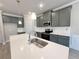 The kitchen has stainless steel appliances, gray cabinets, and a white quartz countertop at 1327 Fern Ridge Ct # 27, Norcross, GA 30093