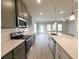 Well-lit kitchen with stainless steel appliances, gray cabinets, and a quartz countertop island at 1327 Fern Ridge Ct # 27, Norcross, GA 30093