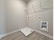 Bright laundry area with tile flooring, utility connections, and wire rack shelving at 1327 Fern Ridge Ct # 27, Norcross, GA 30093
