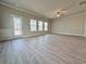 Large living room with vinyl floors, a ceiling fan, and natural light from the sliding glass doors at 1327 Fern Ridge Ct # 27, Norcross, GA 30093