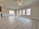 Spacious living room featuring a ceiling fan and multiple windows to create a bright, airy space at 1327 Fern Ridge Ct # 27, Norcross, GA 30093
