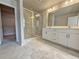 An en-suite bathroom boasts double vanities, glass shower, and walk-in closet at 1327 Fern Ridge Ct # 27, Norcross, GA 30093