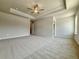 Expansive carpeted main bedroom featuring tray ceiling, fan, and natural light at 1327 Fern Ridge Ct # 27, Norcross, GA 30093