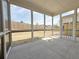 Spacious screened-in porch with concrete flooring and views of the yard at 1327 Fern Ridge Ct # 27, Norcross, GA 30093