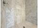 Close-up of the shower featuring stone-look tile surround and tile shower floor at 1327 Fern Ridge Ct # 27, Norcross, GA 30093