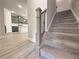 Carpeted staircase with decorative iron spindles leads to the upper level of the home at 1327 Fern Ridge Ct # 27, Norcross, GA 30093