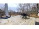 Cozy back deck area featuring outdoor table and chairs with an umbrella for shade and relaxation at 7460 Highway 101, Rockmart, GA 30153