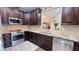 Well-equipped kitchen featuring stainless steel appliances and dark wood cabinets at 7460 Highway 101, Rockmart, GA 30153