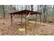 A roofed structure, with open sides, offers space for outdoor activities on this wooded lot at 7460 Highway 101, Rockmart, GA 30153