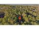 Location pin highlights this home's proximity to vast woods, seen in an aerial view at 2513 Overlake Ln, Stockbridge, GA 30281