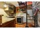 Bar area with wood cabinets, granite counters, wine cooler, and spiral staircase to upper floor at 2513 Overlake Ln, Stockbridge, GA 30281