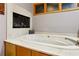 Bathroom features a built-in white bathtub with marble surround and tiled wall fireplace at 2513 Overlake Ln, Stockbridge, GA 30281