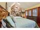 Cozy bedroom with a stone fireplace, hardwood floors, and a window with natural light at 2513 Overlake Ln, Stockbridge, GA 30281