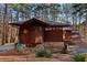 Cozy home showcasing unique architectural wood details, stone accents, and beautiful landscaping at 2513 Overlake Ln, Stockbridge, GA 30281