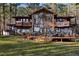 Stunning wooded home featuring a wall of windows and beautiful, large, green front yard at 2513 Overlake Ln, Stockbridge, GA 30281