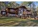Stunning wooded home featuring a wall of windows and beautiful, large, green front yard at 2513 Overlake Ln, Stockbridge, GA 30281