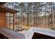 Scenic view from the deck overlooking a backyard with seating and a play structure, surrounded by lush trees and a lake at 2513 Overlake Ln, Stockbridge, GA 30281