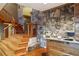 Inviting foyer features a striking stone wall, wooden staircase, and hardwood floors at 2513 Overlake Ln, Stockbridge, GA 30281