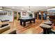 Spacious finished game room with a pool table, wood floors, bar stools, and lounge seating at 2513 Overlake Ln, Stockbridge, GA 30281