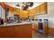 Well-lit kitchen featuring custom cabinets, granite countertops, stainless steel appliances, and a built-in wine cooler at 2513 Overlake Ln, Stockbridge, GA 30281