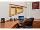 Comfortable office area with natural light, wooden desk, and rolling desk chair at 2513 Overlake Ln, Stockbridge, GA 30281