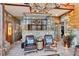 Relaxing sunroom with stone accents, tile floor, and comfortable seating at 2513 Overlake Ln, Stockbridge, GA 30281