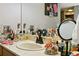 Vanity area with marble countertop, decorative vanity mirror, and personal grooming items at 2513 Overlake Ln, Stockbridge, GA 30281