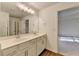 Bathroom features double sinks, a large mirror, and a doorway access to bedroom space at 4118 Haleston Rd, Duluth, GA 30097