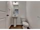 Cozy half bath featuring a pedestal sink, toilet, and neutral decor with classic design at 4118 Haleston Rd, Duluth, GA 30097
