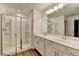 Bathroom features double sinks, a large mirror, and a modern glass-enclosed shower with white tiles at 4118 Haleston Rd, Duluth, GA 30097