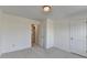 Bedroom with neutral walls, new carpet, and two doors at 4118 Haleston Rd, Duluth, GA 30097