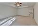 Bright primary bedroom with tray ceiling and a ceiling fan, showcasing a spacious layout and doorway access to hallway at 4118 Haleston Rd, Duluth, GA 30097