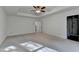 Bright primary bedroom with tray ceiling and a ceiling fan, showcasing a spacious layout and ensuite bathroom at 4118 Haleston Rd, Duluth, GA 30097
