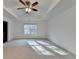 Bright primary bedroom with tray ceiling and a ceiling fan, showcasing a spacious layout and natural light from the window at 4118 Haleston Rd, Duluth, GA 30097