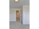 Bedroom with neutral walls, new carpet, and a door leading to the hallway at 4118 Haleston Rd, Duluth, GA 30097