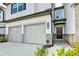 Townhome featuring a two-car garage and brick and siding details at 4118 Haleston Rd, Duluth, GA 30097