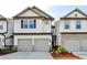 Charming townhome featuring a two-car garage, and beautifully landscaped front yard at 4118 Haleston Rd, Duluth, GA 30097