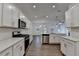 Spacious kitchen with white cabinets, quartz countertops, stainless appliances, and open layout at 4118 Haleston Rd, Duluth, GA 30097