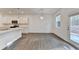 Open-concept kitchen with white cabinets, stainless steel appliances, and a large island at 4118 Haleston Rd, Duluth, GA 30097
