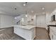 Open floor plan kitchen featuring stainless steel appliances, a large center island and hardwood floors and adjacent living space at 4118 Haleston Rd, Duluth, GA 30097